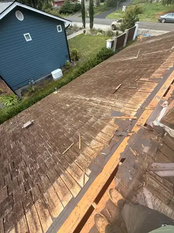 Worn cedar shakes being torn off